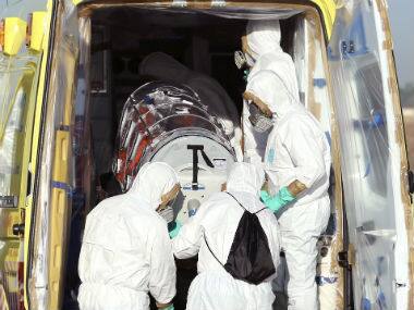 In this photo provided by the Spanish Defense Ministry, aid workers and doctors transfer Miguel Pajares, a Spanish priest who was infected with the Ebola virus while working in Liberia. AP 
