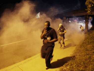 Ferguson shooting: Cops use tear gas to clear protesters off the