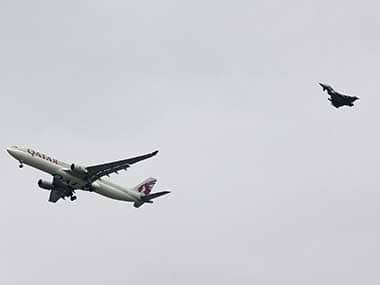 A RAF jet escorts the Qatar Airways jet while it lands at Manchester Airport. AP