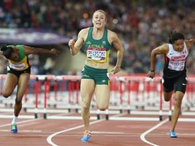 Sally Pearson, centre, of Australia smiles after winning the women's 100 meter hurdles. AP