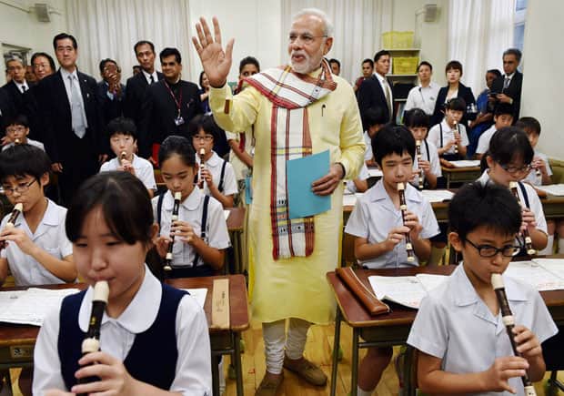  Modi doing some kind of sing-along with kids playing the recorder. PTI