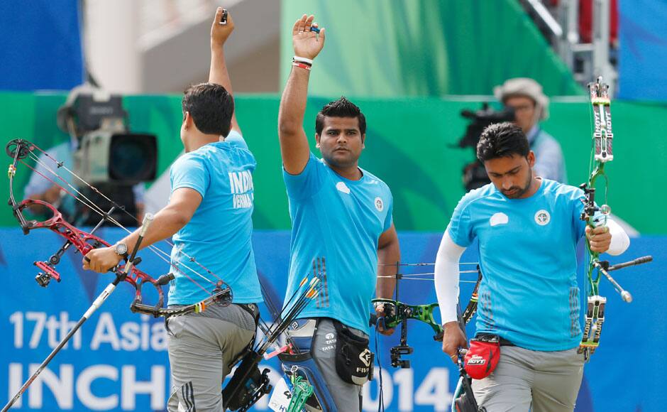 From left, India's team members Abhishek Verma, Raijat Chauhan and Sandeep Kumar celebrate during the compound men's team gold medal archery match. The Indians were ahead 113-111 after the second set. AP