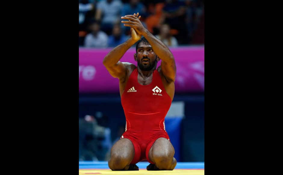 Yogeshwar Dutt celebrates defeating Zalimkhan Yusupov in their men's 65kg freestyle gold medal wrestling match. Yogeshwar had shown his class in the semi-final too. He was trailing 7-9 before he managed to pin down his opponent, China's Katai Yeerlanbeike, in the dying minutes of the match to win 5-0 in a 'victory by fall' verdict to enter the finals. Reuters