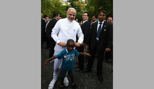 Modi and the black kid. Modi's Facebook Fan page