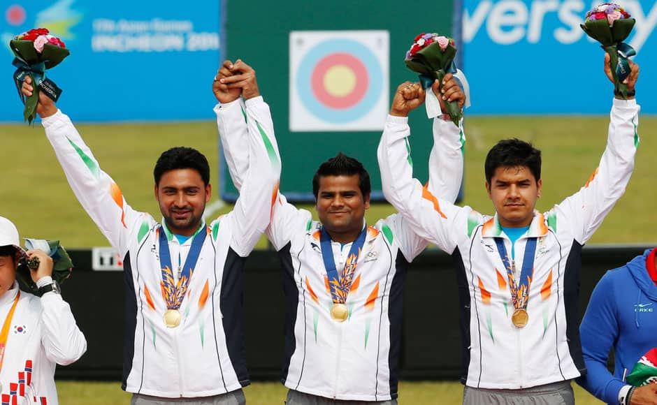 From left, gold medal winners India's team members Sandeep Kumar, Raijat Chauhan and Abhishek Verma celebrate after winning the compound men's team gold medal. It was India's maiden gold medal in archery in Asian Games. AP