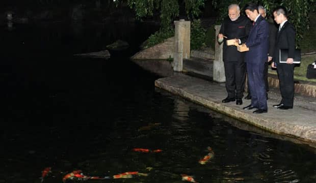 With koi fish. Modi's Facebook Fan page