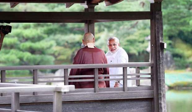 With head priest. Modi's Facebook Fan page