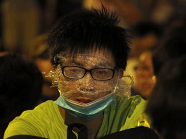 A protester uses a rudimentary protection against pepper spray in Hong Kong on Saturday. Reuters