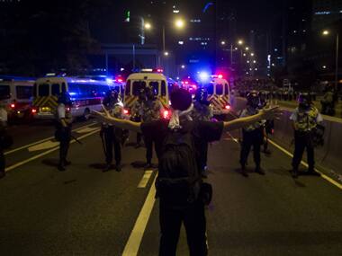 A protester reacts in front of riot police during as fellow demonstrators blocked the main street to the financial Central district at Central in Hong Kong. Reuters