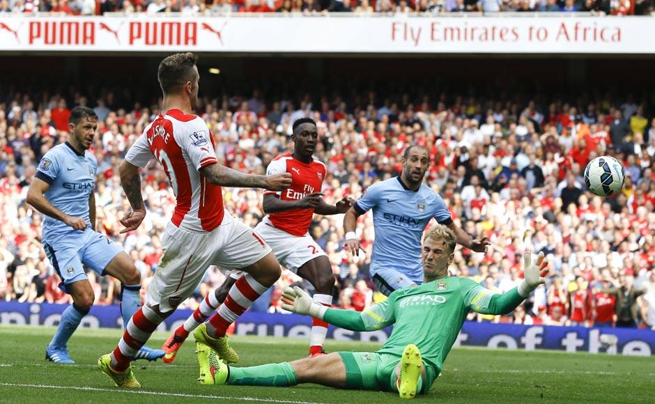 Arsenal's Jack Wilshere, left, scores a goal past Manchester City's goalkeeper Joe Hart d at Emirates Stadium. It was the equaliser after Sergio Aguero had given the visitors the lead. Wilshere had received a lot of criticism for his inconsistent performances and he answered his critics in style against the holders at the Emirates. AP