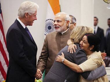 Former US Secretary of State Hillary Clinton embraces Sushma Swaraj as former US president Bill Clinton shakes hands with Prime Minister Narendra Modi. Reuters