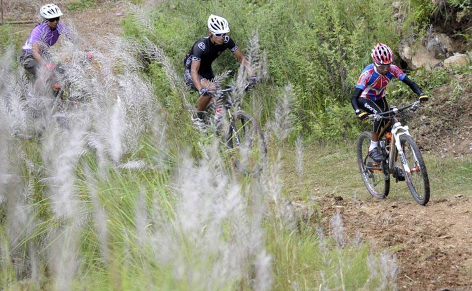 Nepalese cyclist Ajay Pandit Chhetri (R) takes part in a training session in Kathmandu ahead of the 17th Asian Games in Incheon, South Korea. A short and skinny former cycle mechanic from one of the world's poorest countries is hoping to beat the odds and surprise Asia's best mountain bikers at the Asian Games. AFP