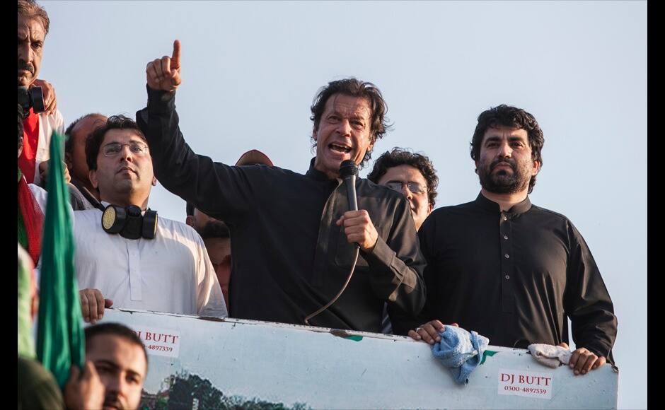 Imran Khan(C), the Chairman of the Pakistan Tehreek-e-Insaf (PTI) political party, addresses supporters during the Revolution March in Islamabad August 31, 2014. Thousands of protesters massed outside the residence of Pakistani Prime Minister Nawaz Sharif on Saturday to demand he step down, after efforts to find a negotiated solution to the country's political crisis failed.Pakistan has been gripped by unrest for more than two weeks, with protest leaders Imran Khan and Tahir ul-Qadri saying they will not back back down unless Prime Minister Nawaz Sharif resigns. On Saturday Sharif once again said he would not go. REUTERS