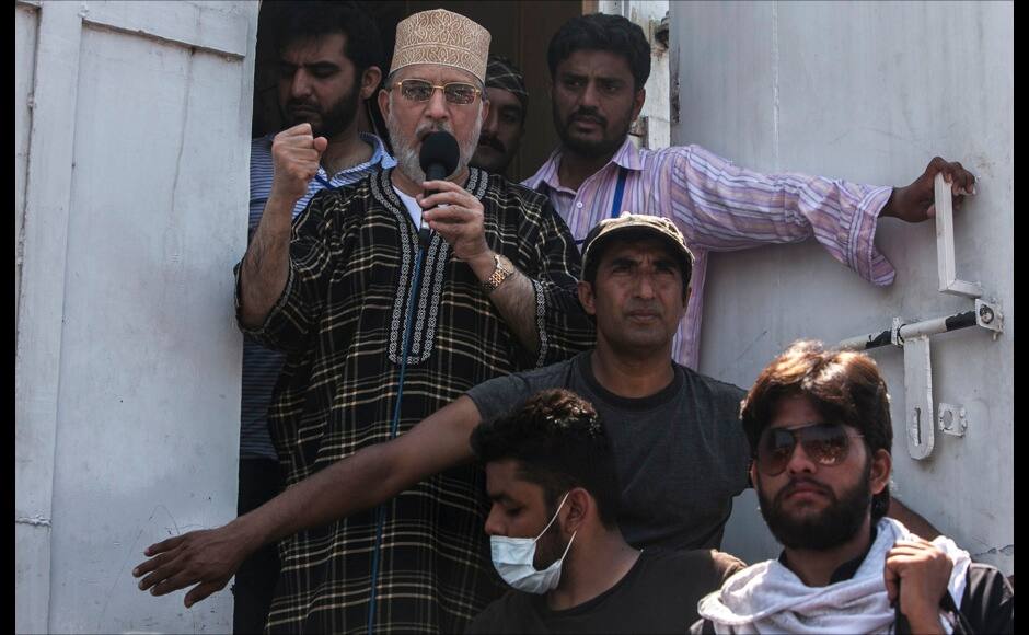 Tahir ul-Qadri, Sufi cleric and leader of political party Pakistan Awami Tehreek (PAT),addresses supporters during the Revolution March in Islamabad August 31, 2014. Thousands of protesters massed outside the residence of Pakistani Prime Minister Nawaz Sharif on Saturday to demand he step down, after efforts to find a negotiated solution to the country's political crisis failed.Pakistan has been gripped by unrest for more than two weeks, with protest leaders Imran Khan and Tahir ul-Qadri saying they will not back back down unless Prime Minister Nawaz Sharif resigns. On Saturday Sharif once again said he would not go. REUTERS