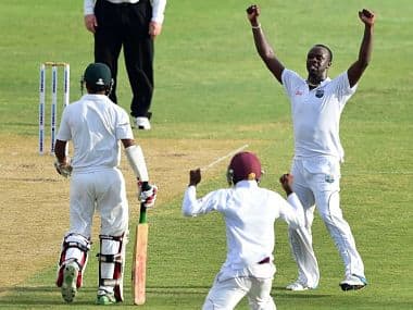 Kemar Roach celebrates his fifth wicket, as Taijul Islam (L) of Bangladesh leaves the field after being caught by Shannon Gabriel on day two. AFP