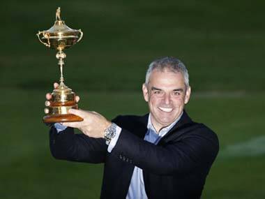Paul McGinley proudly poses with the Ryder Cup trophy. Reuters