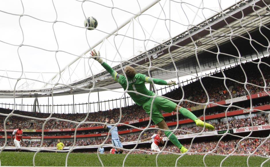 Manchester City's goalkeeper Joe Hart fails to get to the ball as Arsenal's Alexis Sanchez hits a sumptuous volley to score Arsenal's second goal and give the hosts the lead. The match ended in a 2-2 draw at the Emirates Stadium. AP 