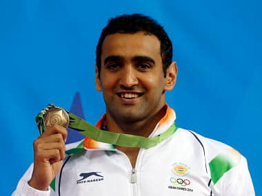 India's Sandeep Sejwal poses with his bronze medal after the men's 50m breaststroke final swimming competition. Reuters