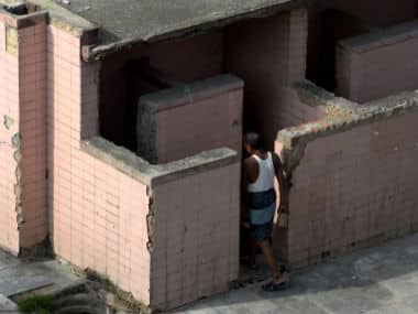 A resident entering a public toilet in Delhi. AFP 