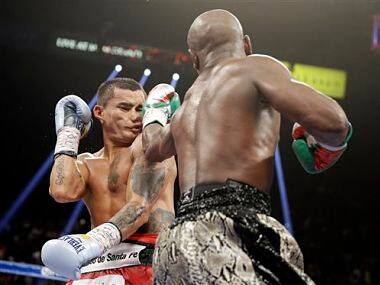 Floyd Mayweather punches Marcos Maidana, left, during their title boxing bout. AP