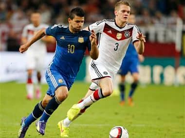 Germany's Matthias Ginter, right, and Argentina's Sergio Aguero challenge for the ball during the friendly soccer match between Germany and Argentina in Duesseldorf, Germany. AP