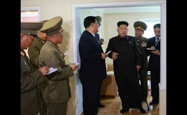 Photos: Kim Jong-un limps back to public view, with a cane