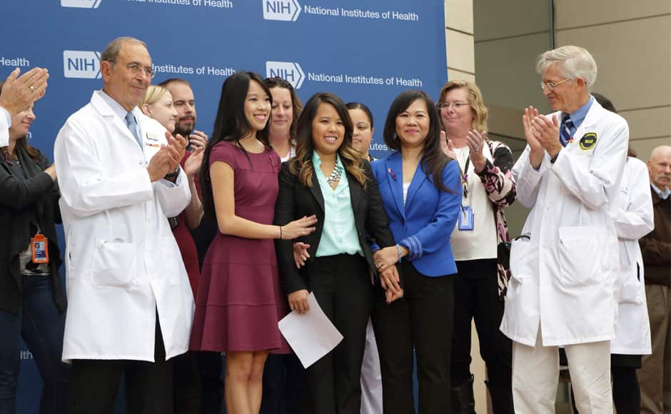 Dallas nurse Nina Pham (C) is flanked by her sister Cathy and her mother during a news conference at the National Institutes of Health (NIH) in this handout photo provided by the NIH October 24, 2014 in Bethesda, Maryland. Pham was discharged and declared Ebola-free on Friday after undergoing treatment at the NIH since October 16, 2014. REUTERS/National Institutes of Health/Handout via Reuters