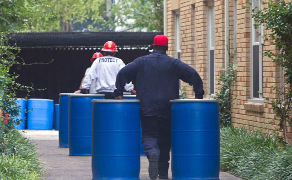 Members of the Protect HazMat team prepare to clear the contents of the apartment of a health worker who was infected with the Ebola virus at Texas Health Presbyterian Hospital in Dallas, Texas October 13, 2014. The nurse, whose name has not been released by officials, has been identified by friends and family and in media reports as Nina Pham, 26. Reuters independently verified her identity with a Sunday school teacher at the church where her family worships and through a public records check of her address. REUTERS