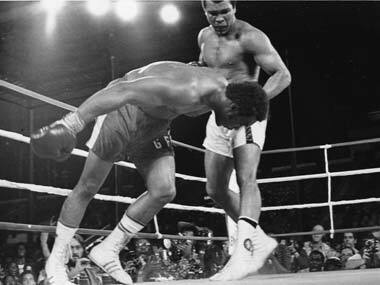 Ali watches Foreman fall to the floor. AP