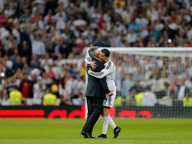 Real Madrid's coach Carlo Ancelotti, left, and Cristiano Ronaldo embrace at the end of a Spanish La Liga soccer match between Real Madrid and Barcelona. AP