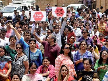 Bangalore residents protest the rising sexual assault cases in the city. PTI