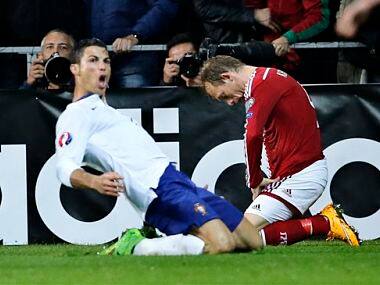 Cristiano Ronaldo, left, celebrates his last minute goal next to Denmarks Michael Krohn-Dehli. AP