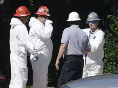 A hazmat cleaning crew confer in the parking lot of The Village Bend East apartments where a second healthcare worker lives who also tested positive for Ebola. AP 
