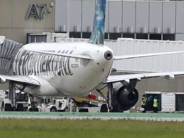 Two workers unload bags from the Frontier Airlines plane that Amber Joy Vinson flew from Cleveland to Dallas on Monday, at a terminal at Cleveland Hopkins International Airport. AP 