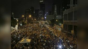 Protesters press Hong Kong leader to quit, China tells US to back off