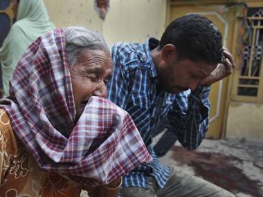 Families mourn the death of their relatives in Arnia village of Jammu. AP