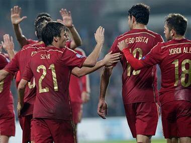 Spain's David Jimenez Silva, left, is congratulated by team members after he scoring. AP