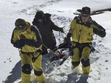 In this photo released by the Nepalese Army, rescue team members carry a victim of an avalanche before they airlift the body from Thorong La pass area, in Nepal. AP 