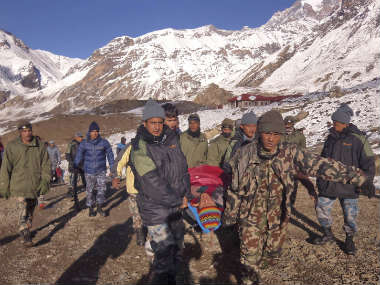 In this photo provided by the Nepalese army, soldiers carry an avalanche victim before he is airlifted in Thorong La pass area, Nepal. AP