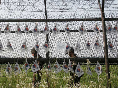South Korean army soldiers patrol through the military wire fence with national flags at the Imjingak Pavilion in Paju, near the border with North Korea. AP 