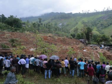 A crowd gathers to watch rescue operation at the site of a mudslide at the Koslanda tea plantation in Badulla district. AP
