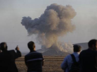 In this Wednesday, Oct. 8, 2014 file photo, Turkish Kurds watch as airstrikes hit Kobani, inside Syria, as fighting intensifies between Syrian Kurds and the militants of Islamic State group. AP 