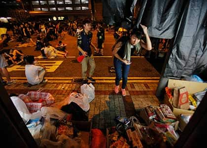 Student protesters enter a makeshift supply station as thousands occupy a main thoroughfare in Hong Kong. Associated Press