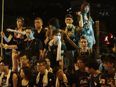 Student protesters stand outside the government complex where Hong Kong's Chief Executive Leung Chun-ying's office is located. AP