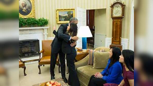 Nurse, now Ebola free, receives a hug from Barack Obama