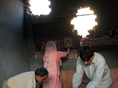 Damaged homes of Indian villagers near the LoC. AFP