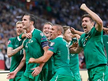 Ireland's players celebrate after scoring during the Euro 2016 group D qualifying soccer match between Germany and Ireland. AP