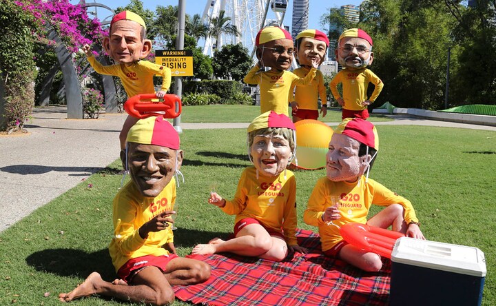 Photos: As G20 begins, protestors take to streets wearing masks with leaders faces