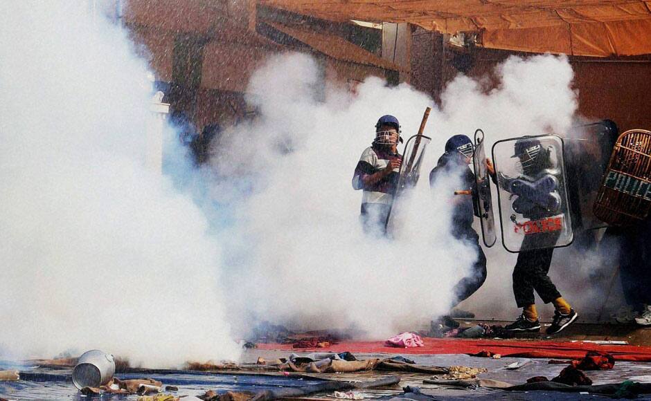 Hisar: Police use tear gas to disperse supporters of controversial guru Sant Rampal outside Satlok Ashram in Hisar on Tuesday. Supporters of Rampal indulged in clashes with the police to resist his arrest. PTI