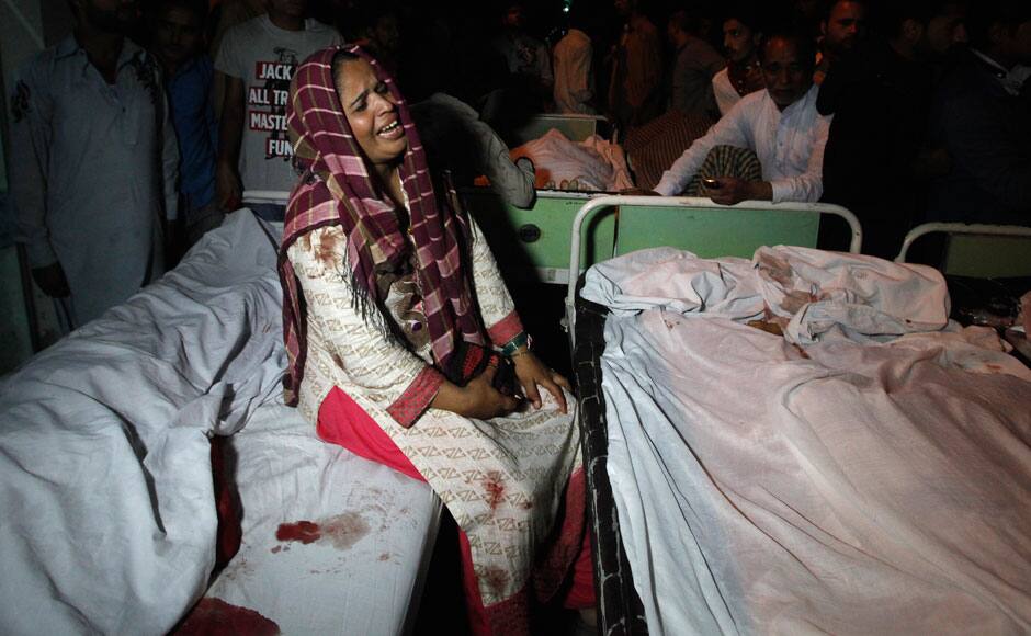 A woman mourns near the bodies of relatives who were killed in suicide bomb attack in Wagah border near Lahore November 2, 2014. At least 45 people were killed on Sunday when a suicide bomber blew himself up on the Pakistani-Indian border, police said, just after a daily ceremony when troops from both sides simultaneously lower the two nations' flags. REUTERS